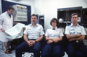 Dr. Burton, left, analyzes a printout of the physiological reactions of three tests subjects during a test of the drug Temazepan at the US Air Force Drug Testing Laboratory.